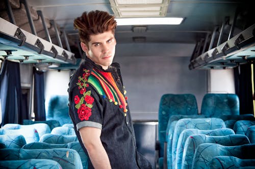 Man Standing Between Passenger Seats