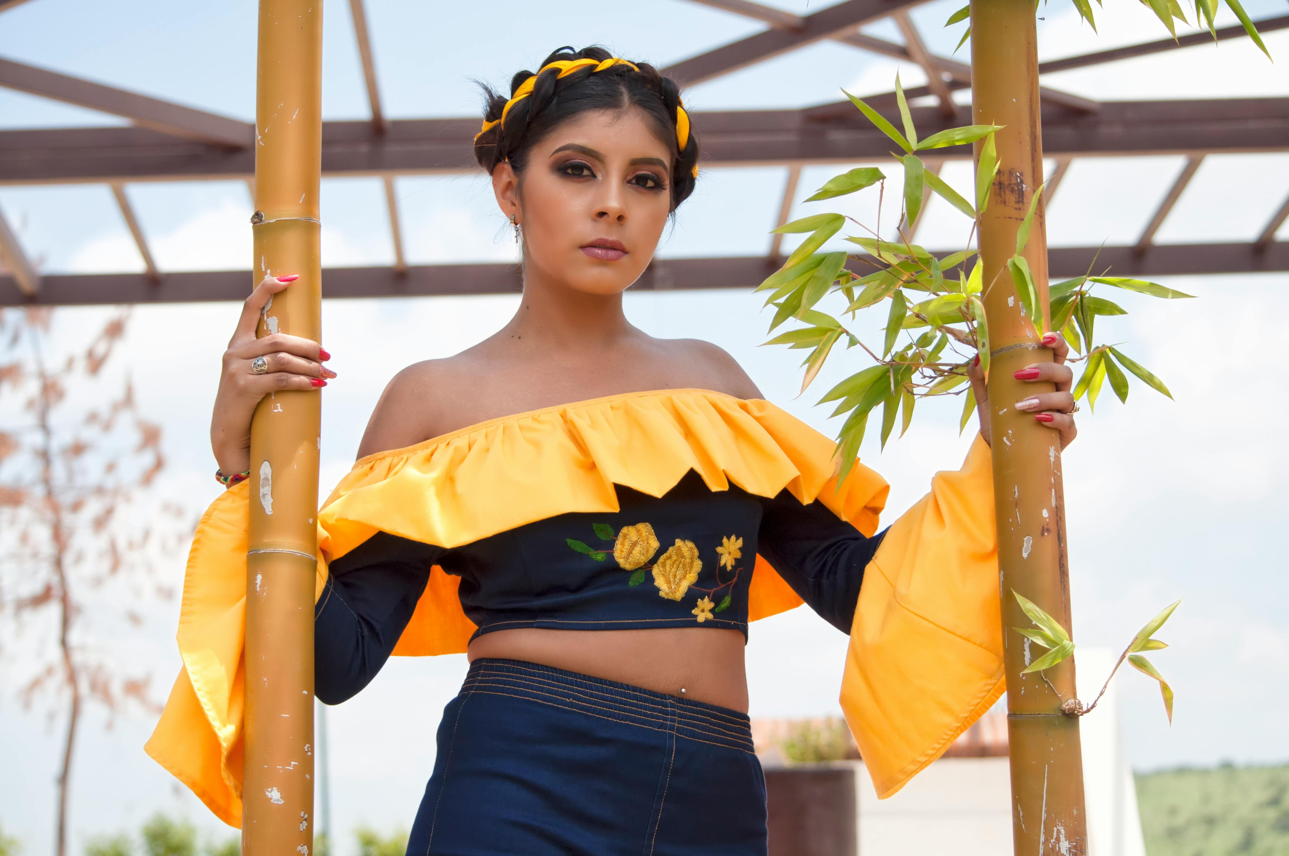 一位充满活力的时尚女性在户外与竹子合影，展现文化优雅