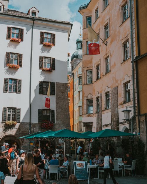 Free Bustling European old town street with outdoor cafe seating, lively atmosphere. Stock Photo