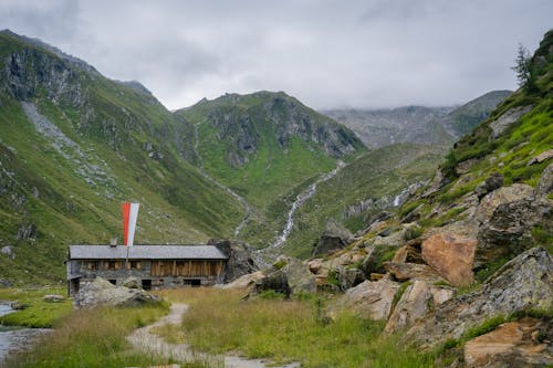 Mountains Landscape with a Wooden Building in Austrian Alps