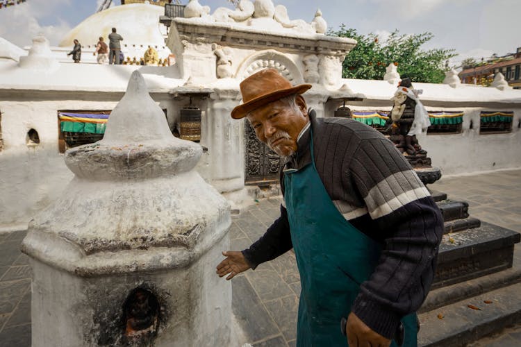 Old Man In Apron Near Stone Oven 