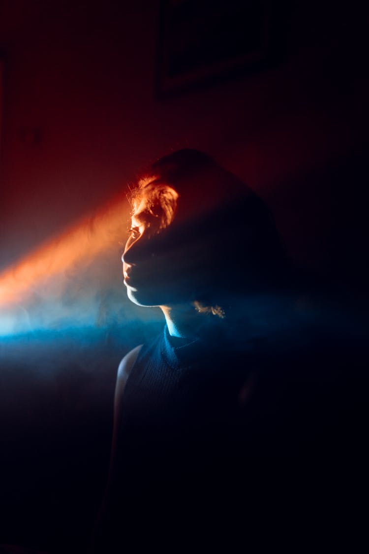 Woman With Lights Projection On Face On Dark Background