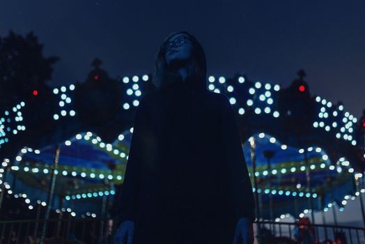 Man in Black Hoodie Standing during Night Time