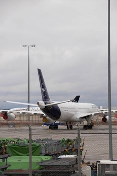 Wide-body airplane parked at an airport tarmac, showcasing aviation industry.