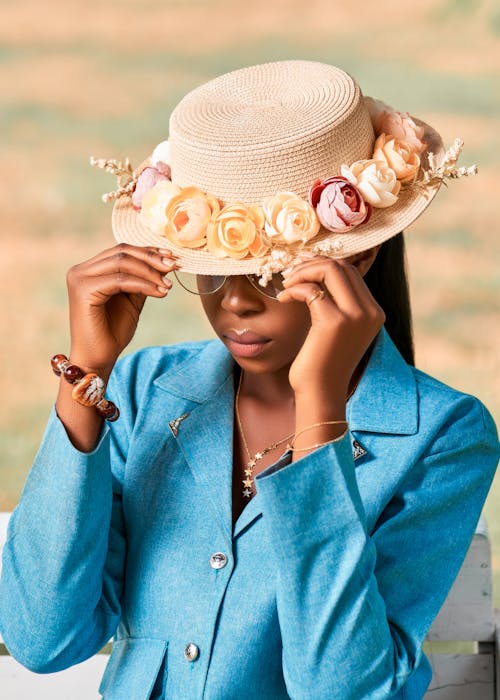 A Woman in Blue Long Sleeves Wearing Brown Hat