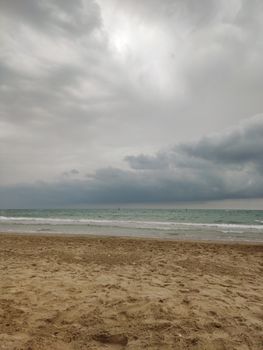 Scenic view of Marotta Beach with cloudy skies and gentle waves in Marche, Italy.