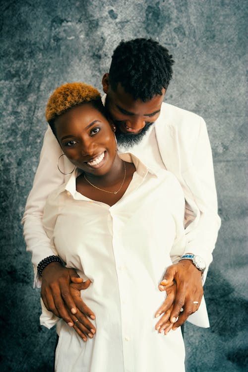 Happy Couple Wearing White Clothes Standing Together Holding Hands 