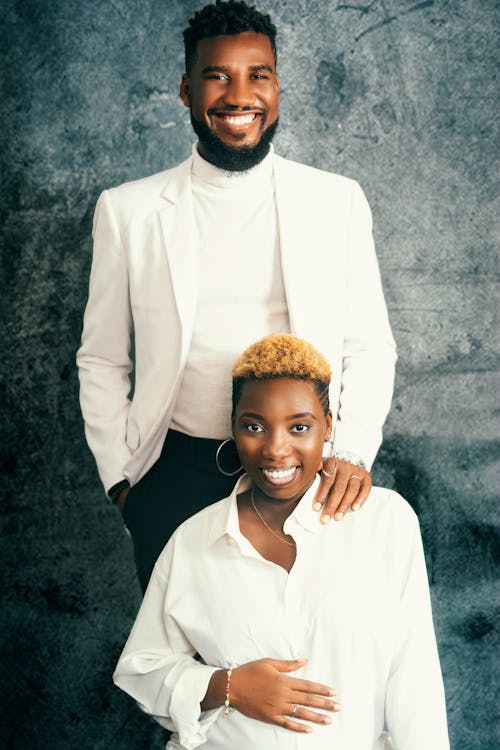 Happy Couple Wearing White Clothes Posing on Gray Background