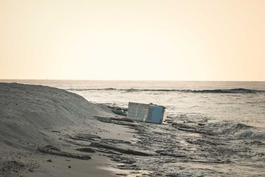 Metal Trash on a Sandy Beach, and Seascape with Waves