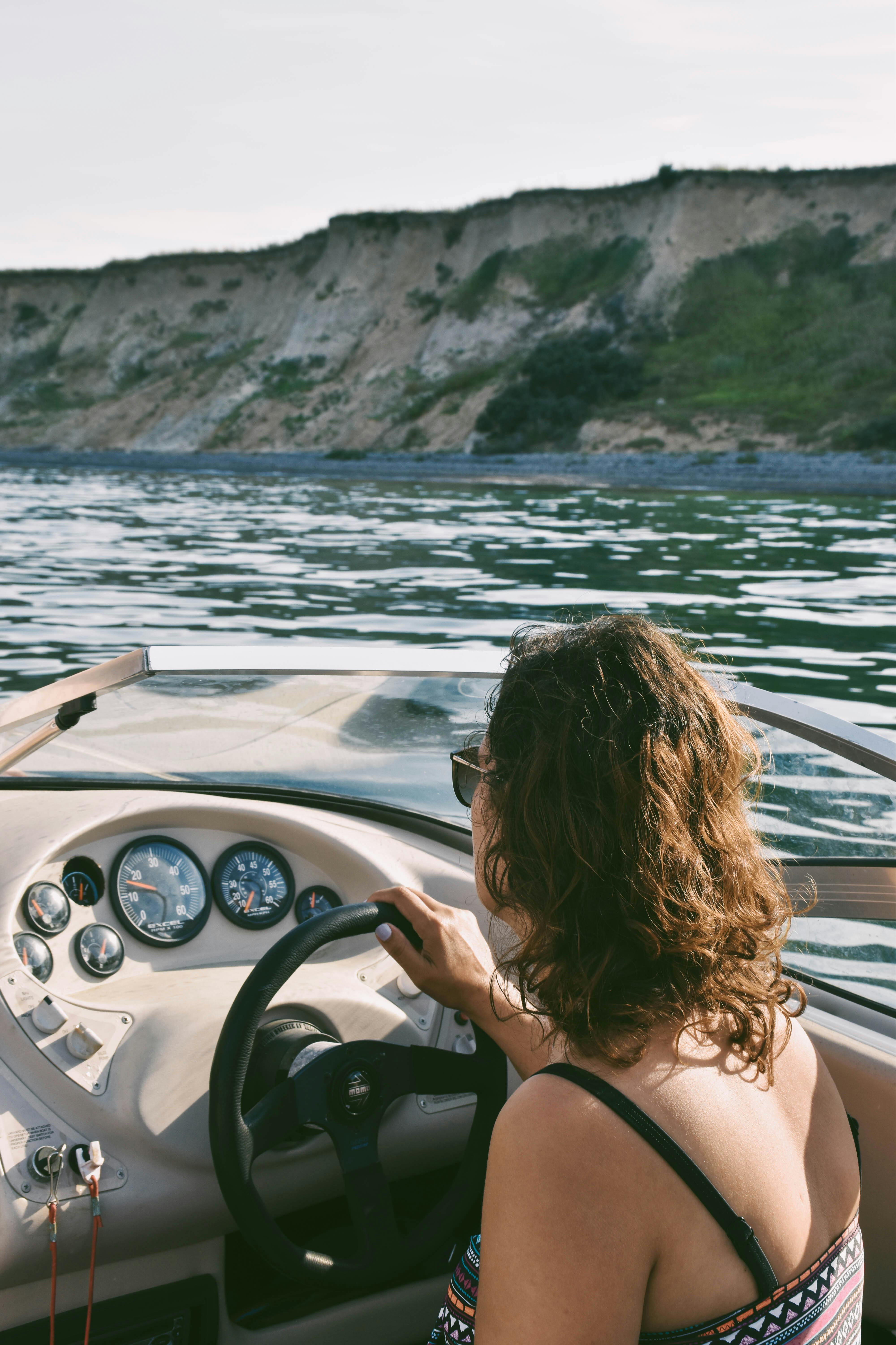 person driving a boat on water