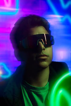 A young adult wearing futuristic sunglasses surrounded by vibrant neon lights.