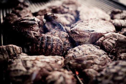 Juicy grilled steaks on a barbecue grill, perfect for a delicious meal.