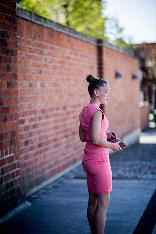 Free Woman Wearing Pink Sleeveless Dress Standing Stock Photo