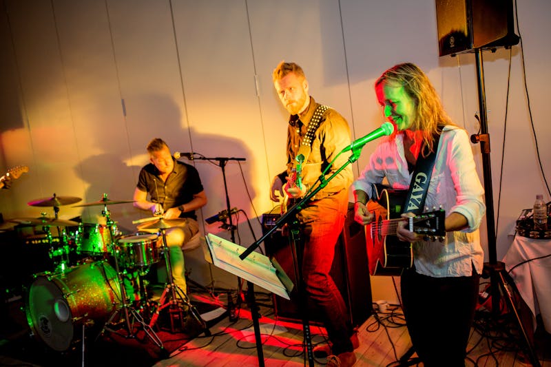 Close-up of acoustic guitar being played at concert
