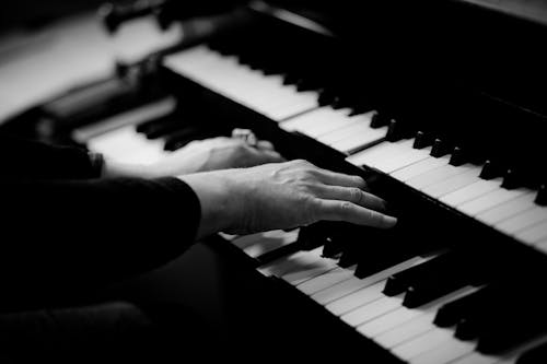 Person Playing Musical Organ Grayscale Photo