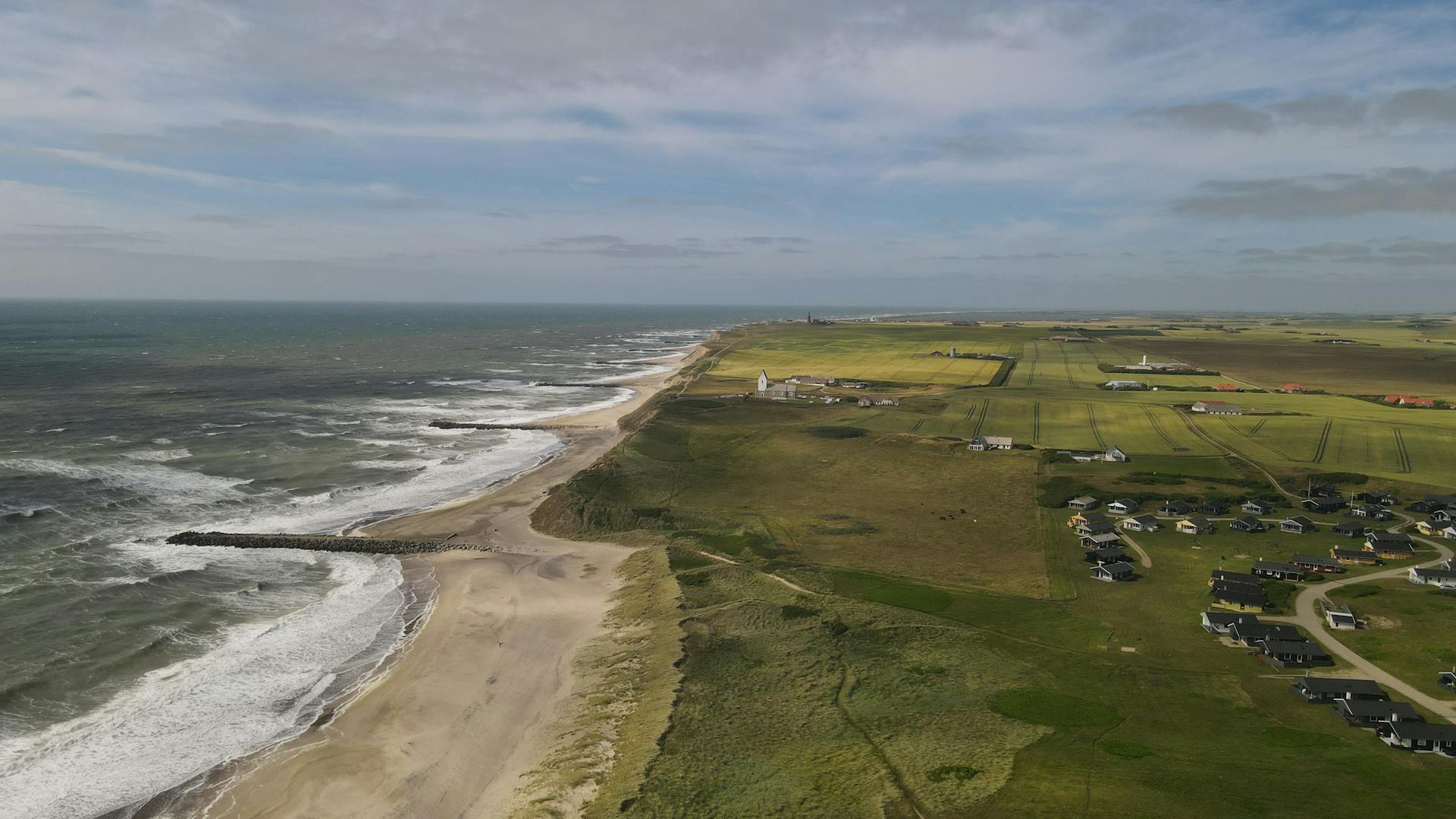 Explore the scenic coastline and countryside of Lemvig, Denmark from above.