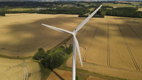 Aerial View of a Wind Turbine on a Cropland 