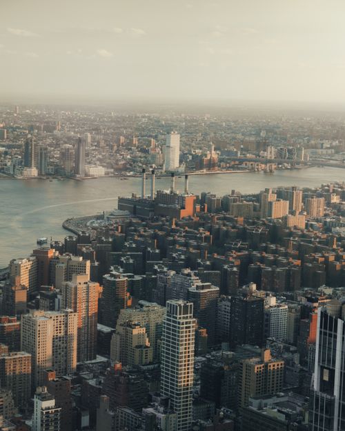 Free Breathtaking aerial view of New York City skyline during dusk, highlighting iconic skyscrapers and the East River. Stock Photo