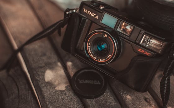 Close-up of a classic Yashica camera highlighting its vintage charm on a rustic wooden background.