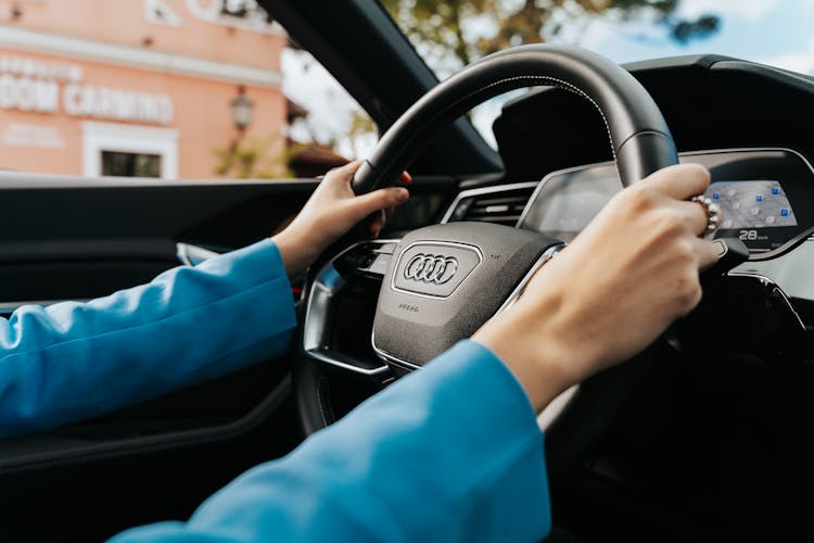 Close-up Of Woman Holding The Wheel In A New Audi Car 