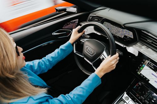 Free Woman wearing blue blazer driving an Audi in Curitiba, Brazil. Stock Photo
