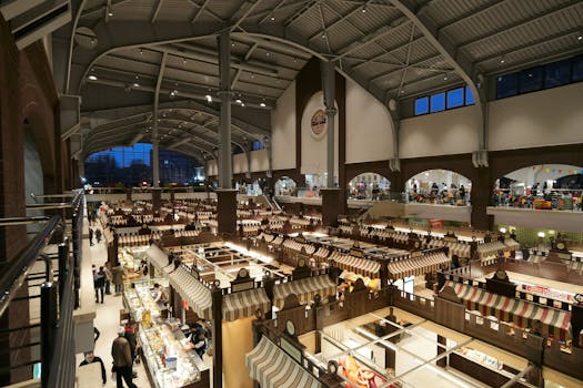 Explore the bustling indoor market hall in Kharkiv, Ukraine, showcasing various stalls under a vast arched ceiling.