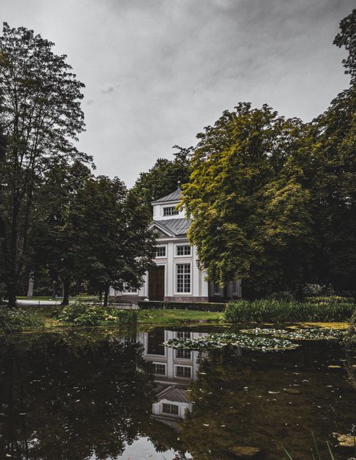 Free Beautiful reflection of a house amidst green trees in Innsbruck, Tyrol, Austria. Stock Photo