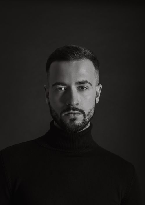 Free Black and white portrait of a man in a turtleneck, showcasing sophisticated style and mood. Stock Photo