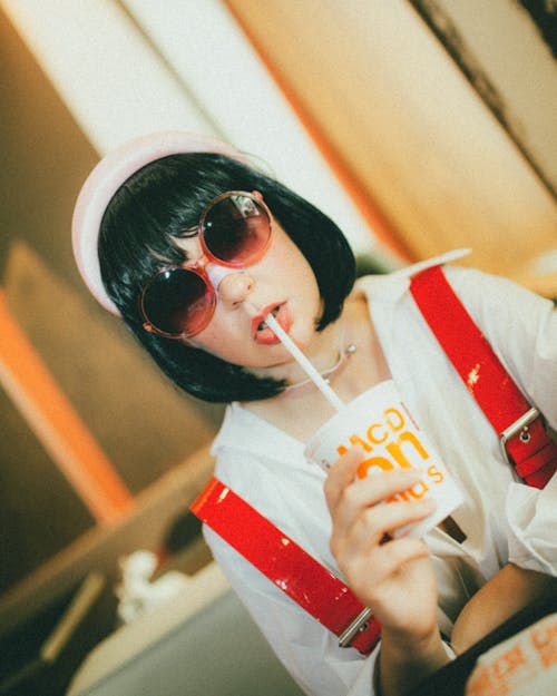 A Woman in White Long Sleeves Wearing Sunglasses