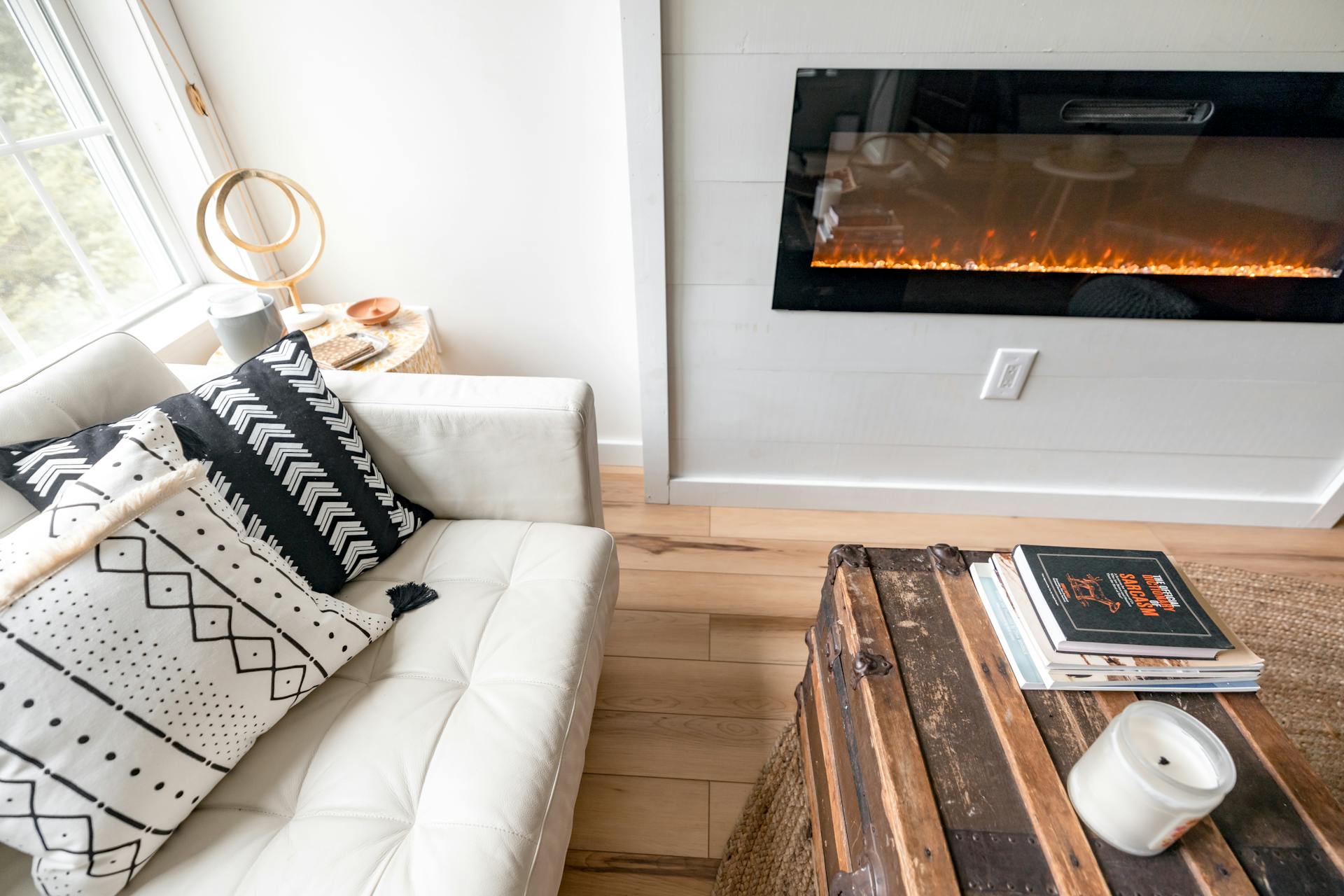 Inviting living room with modern fireplace and comfy couch in a Maine home, perfect for relaxation.