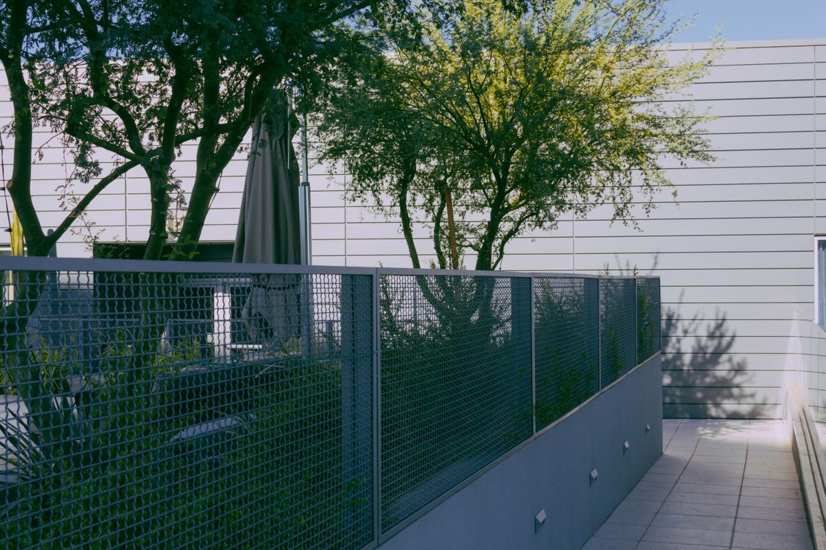 Modern porcelain patio and landscaped garden at a residential home