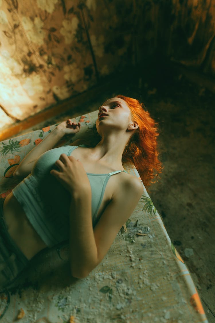 Redhead Woman Lying On A Rough Surface 