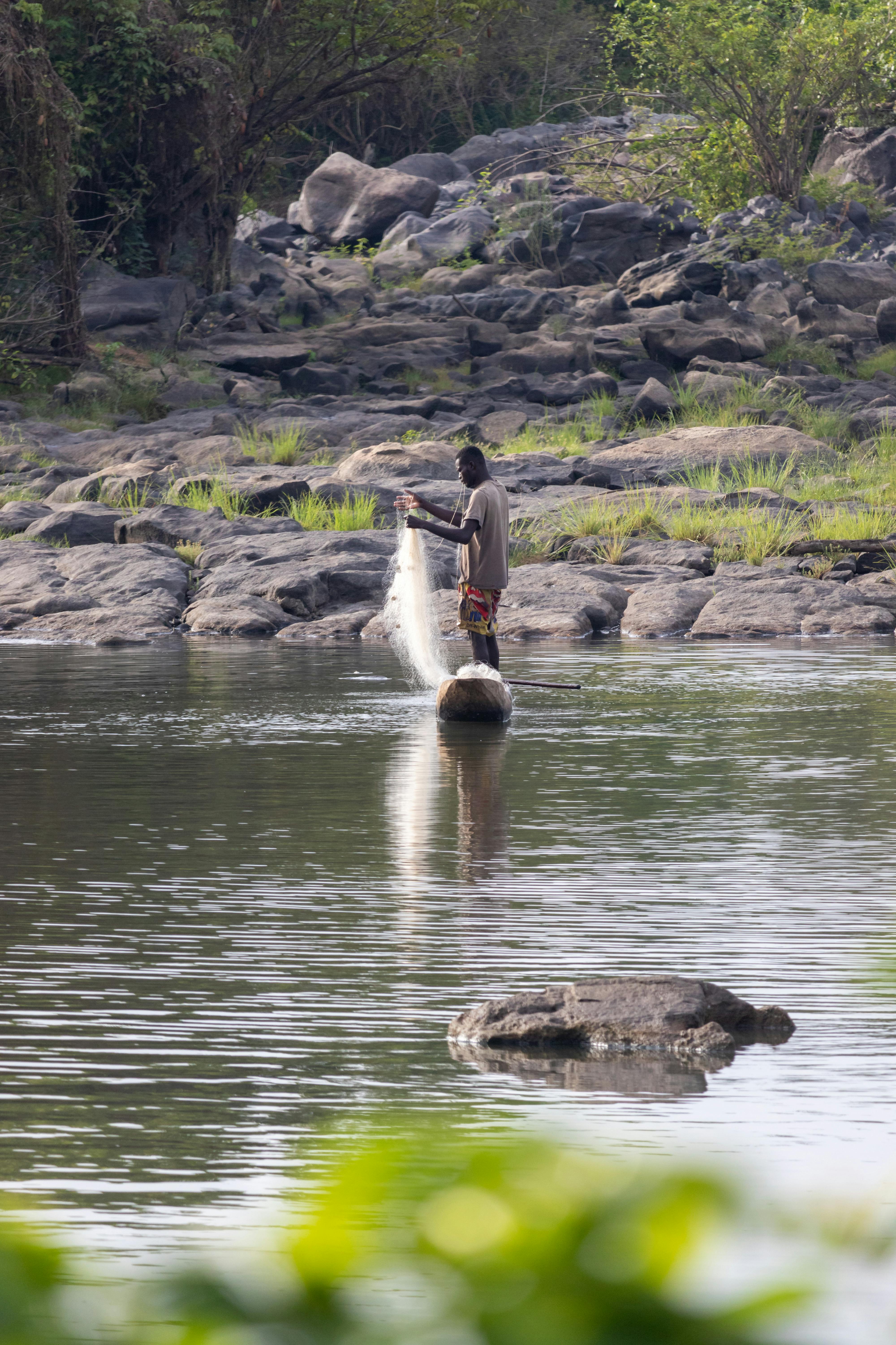 Man Throwing a Fishing Net - PixaHive