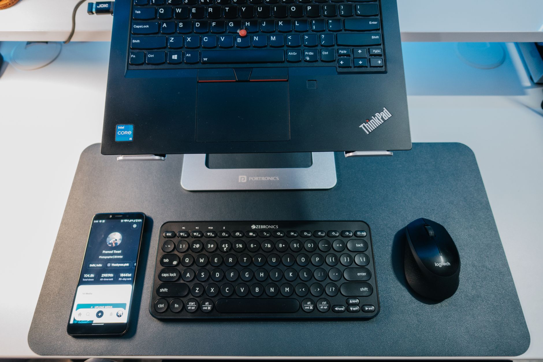 How to Fix Bluetooth Lag on Phone With a Mouse or Keyboard A sleek workspace with a phone, keyboard, and mouse