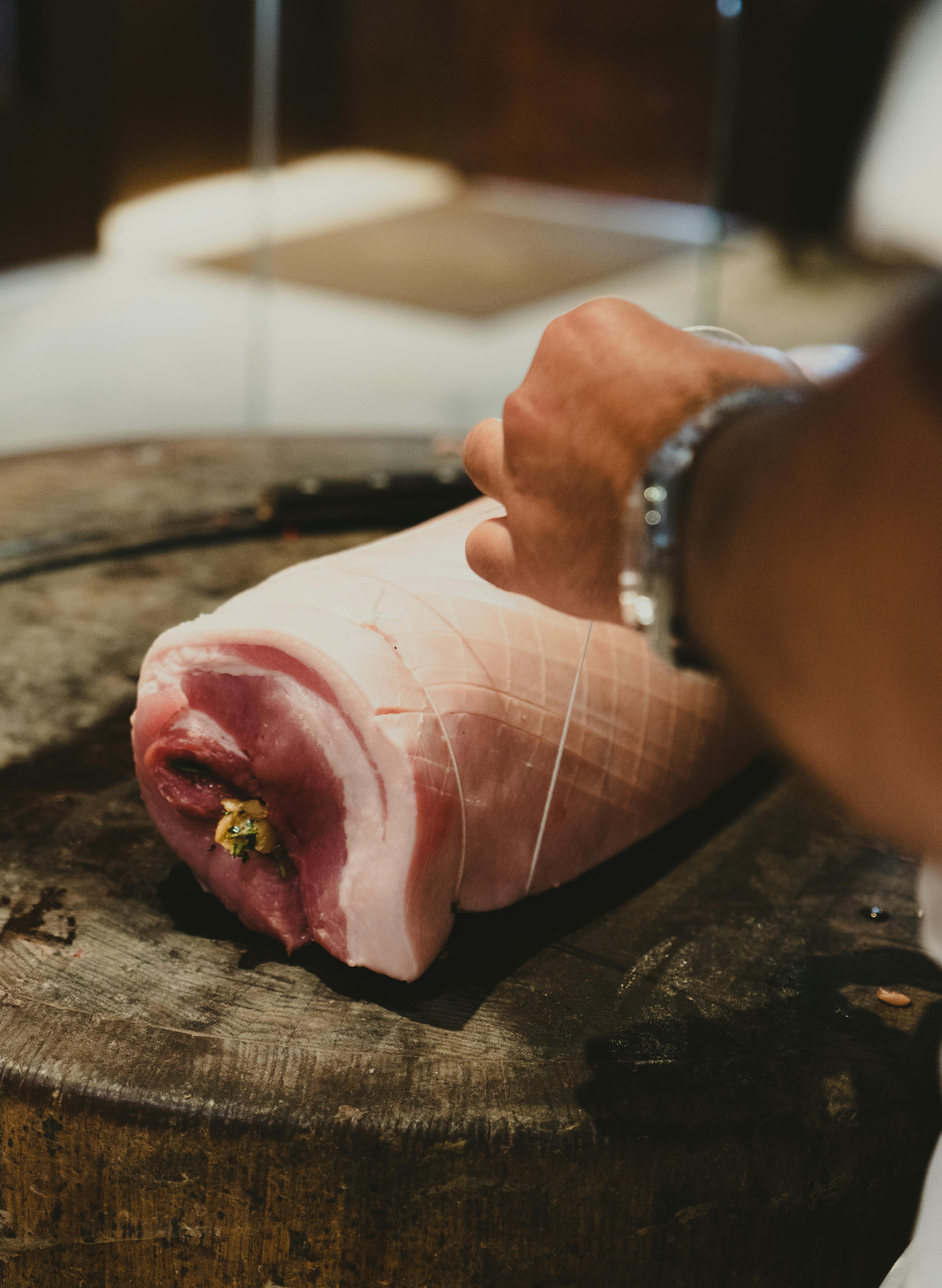 A Person Tying the Meat · Free Stock Photo