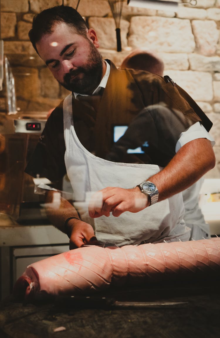 Man Tying Pork Meat