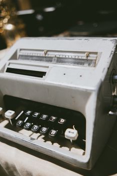 Close-up of a vintage typewriter in natural light, showcasing its aged keys and mechanical details.