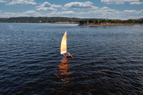 Free A serene scene of a sailboat on Lake Pepin in Lake City, MN, under a clear sky. Stock Photo