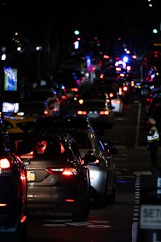 Intense night traffic on a busy street in New York City, filled with cars and city lights.