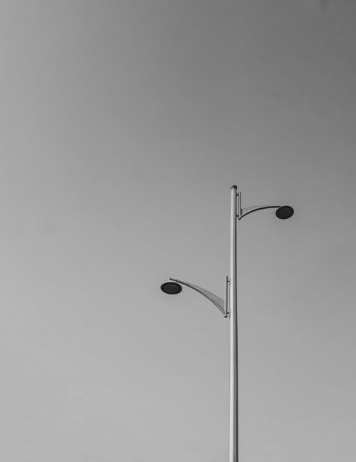 Free Monochrome image of a modern streetlight against a clear sky in Dubai. Stock Photo