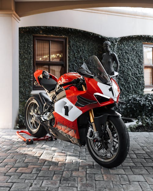 Red Ducati Panigale Sports Bike Parked in Front of House