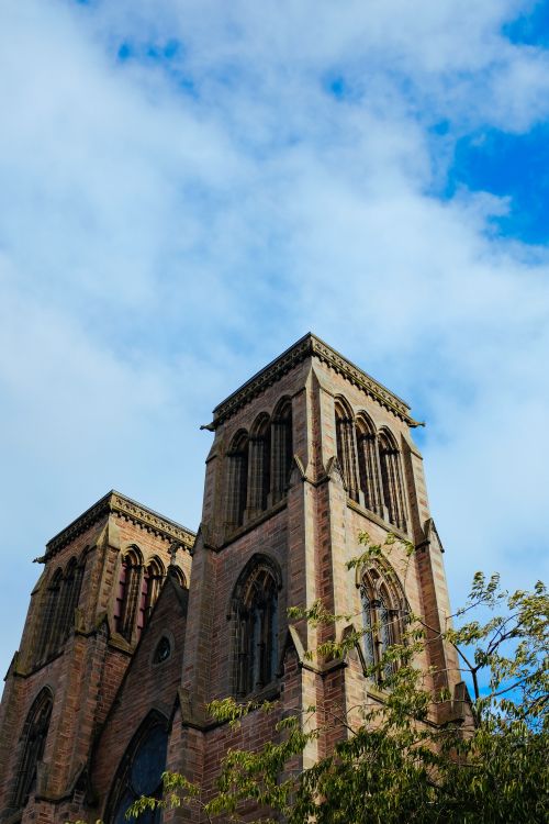 Free A stunning architectural photograph of historic church towers set against a vibrant blue sky. Stock Photo