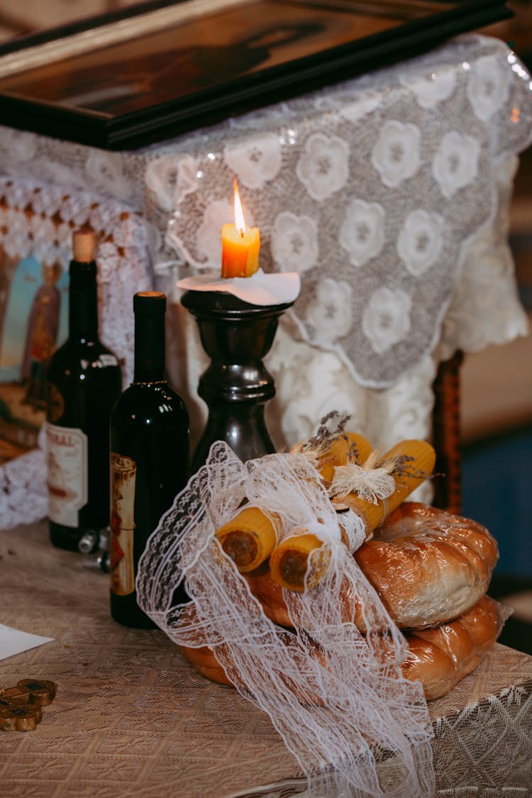 Lit Candle And Breads On The Table