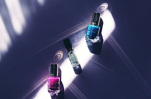 A close-up view of colorful nail polish bottles on a dark surface with striking light patterns.