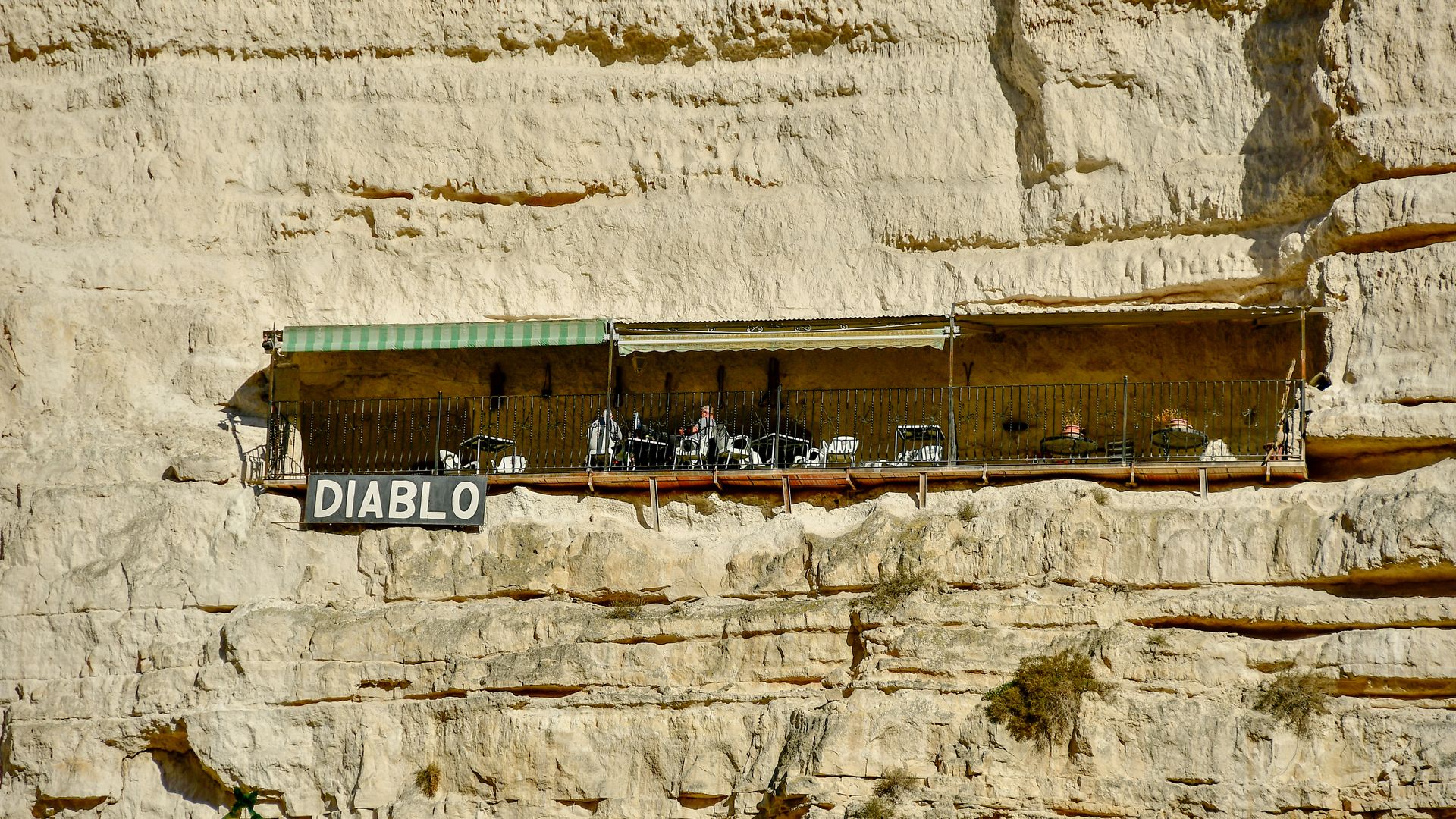 Explore the cliffside Diablo restaurant in Alcalá del Júcar, Spain, carved into natural rock.