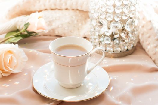 A serene coffee scene with a delicate cup, soft pink roses, and sparkling crystals on a pastel backdrop.