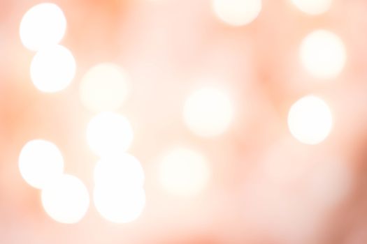Abstract image of soft bokeh lights on a pink background, perfect for artistic and design purposes.