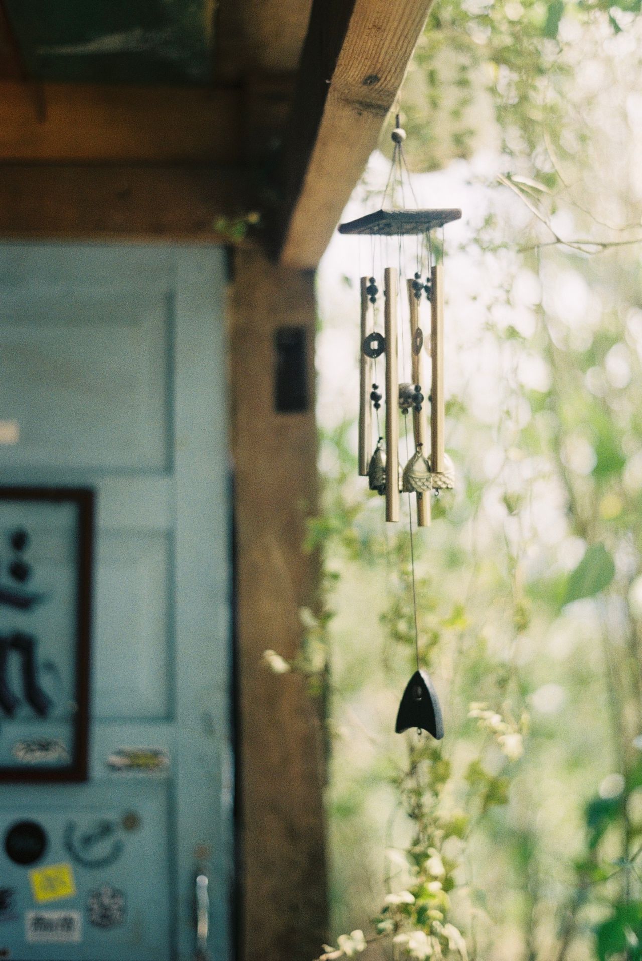 red-white-and-blue-wind-chimes A wind chime hanging from a wooden beam