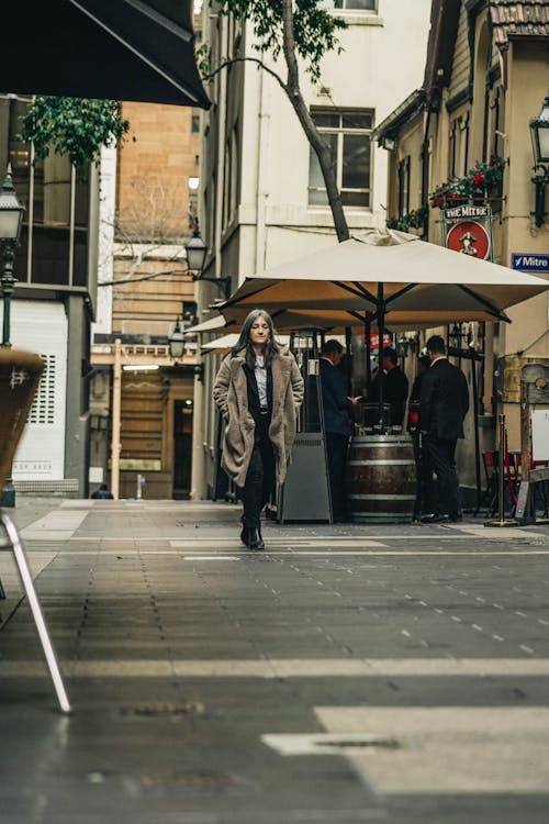 Free A Woman Walking in a City Stock Photo