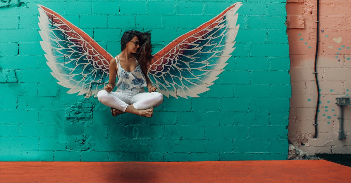 Woman Taking Picture Beside Wings Decor